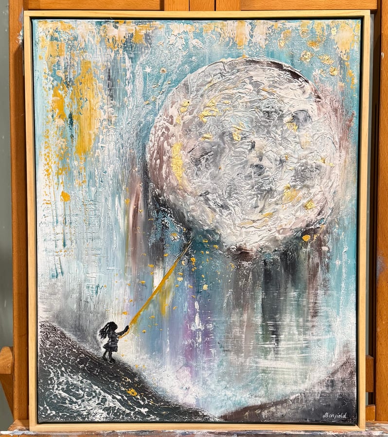 A small figure reaching a golden thread up to a huge textured moon.