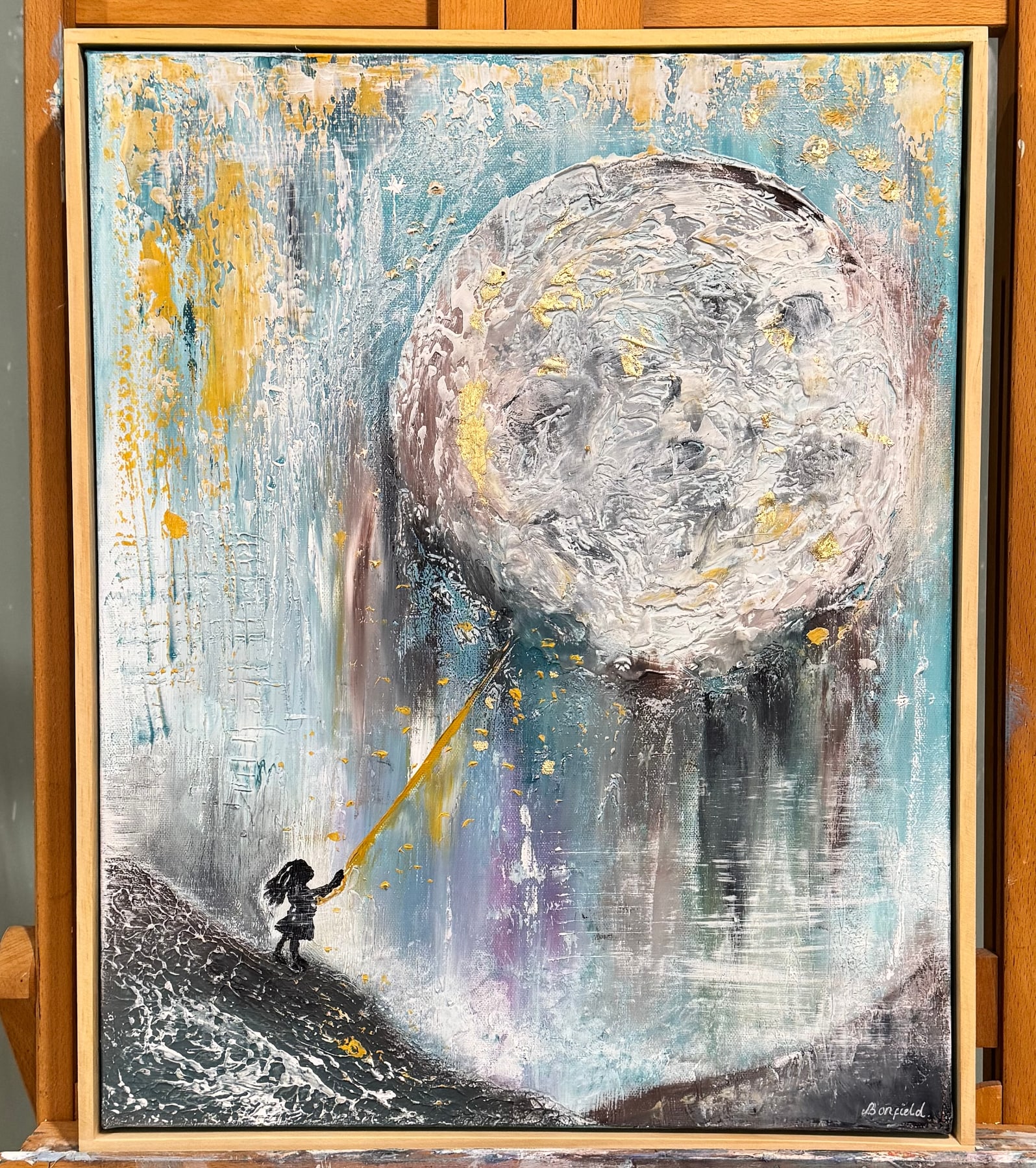 A small figure reaching a golden thread up to a huge textured moon.